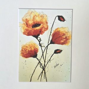 Watercolor painting of three orange poppies with black ink stems and splatters, matted in white.